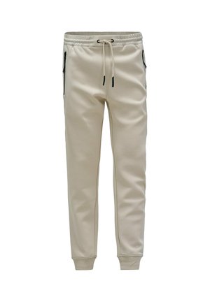 Pantalones de chándal color crema, ajustados, con cintura elástica, cordón, bolsillos laterales con cremallera y puños acanalados en los tobillos.