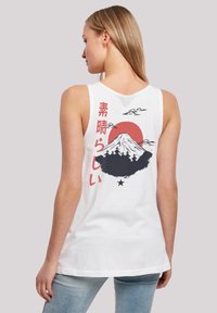 White tank top featuring a mountain graphic with a red sun, Japanese text, and black details. Soft fabric with a relaxed fit.