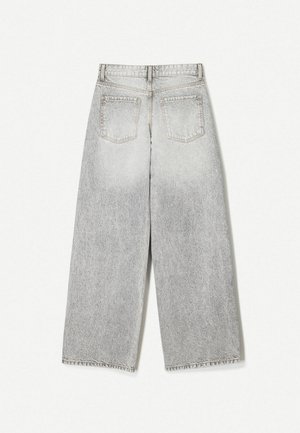 Wide-leg gray denim jeans with a faded finish, featuring two back pockets and raw hem detail.