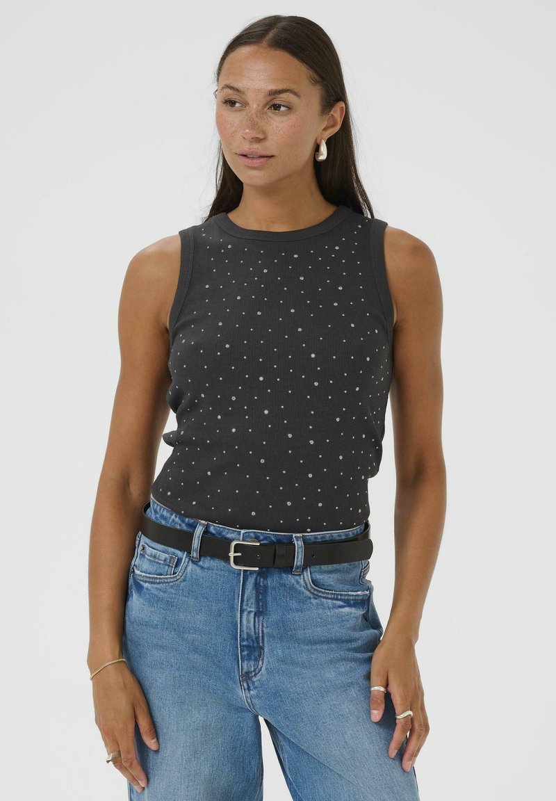 Dark gray sleeveless top featuring a textured pattern of small dots. Paired with light blue denim jeans and a black belt.