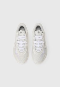Pair of white and light gray athletic sneakers with white laces, viewed from above on a white background.