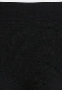 Black knitted fabric with a smooth texture; features a stretchy waistband at the top and a uniform color throughout.