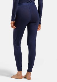 Navy blue leggings with a soft texture, slim fit, and elastic waistband. Ribbed cuffs at the ankles. Suitable for casual or active wear.