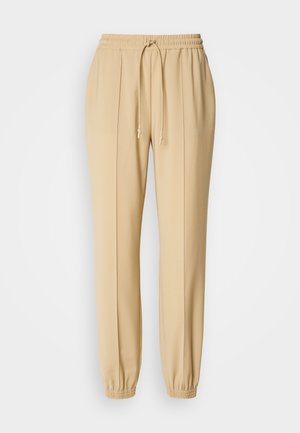 Joggers beige leggeri con vita elastica e cordoncino, gamba tapered con polsini, caratterizzati da pieghe frontali per un tocco di design in più.