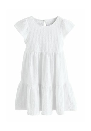 White textured short-sleeve toddler dress with round neckline, gathered waist, tiered skirt, and button closure at back.