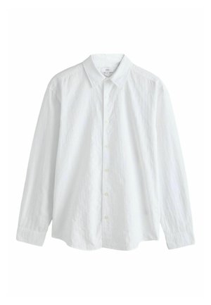 White long-sleeve shirt made of textured fabric, featuring a classic collar and button closure, with a relaxed fit and cuffed sleeves.