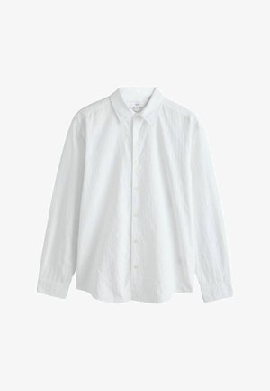 White long-sleeve shirt made of textured fabric, featuring a classic collar and button closure, with a relaxed fit and cuffed sleeves.