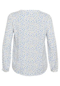 Bluza dugih rukava s opuštenim krojem, bijeli materijal s plavim točkicama i okruglim izrezom. Manšete su nabirane.