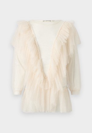 Blouse ivoire à manches longues avec un bord en tulle transparent et volanté formant un profond décolleté en V, agrémentée de légers accents pailletés sur toute la surface.