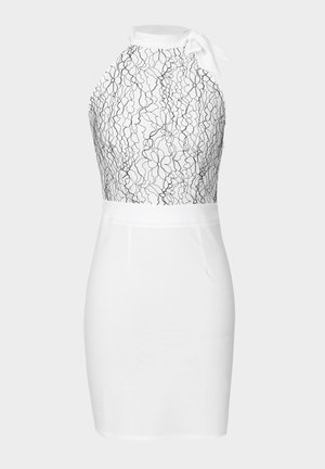 White dress with a fitted silhouette. Top features black lace floral pattern; bottom is smooth white fabric. Includes a tie at the neck.