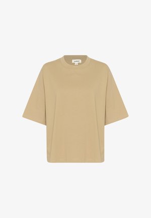 Camiseta de gran tamaño color beige, confeccionada en tela suave, con cuello redondo y mangas cortas. No se aprecian patrones ni adornos.