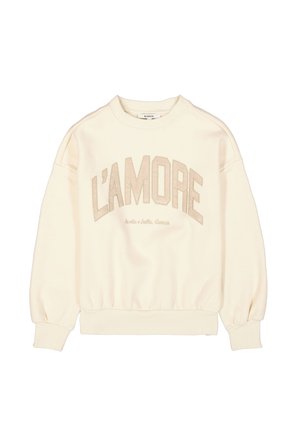 Sweatshirt crème avec des épaules tombantes, des poignets et une taille élastiques. Présente "L'AMORE" en lettres beiges sur le devant.