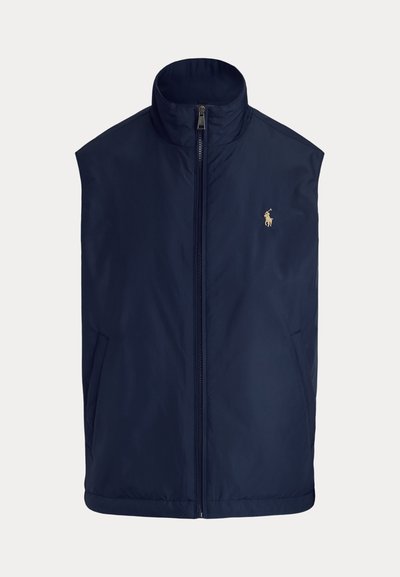 Mörkblå ärmlös väst i lätt tyg, med hög krage, frontdragkedja och liten broderad logga på vänster bröst.