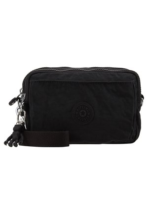 Sort nylon crossbody taske med lynlås, der har en rund logo applikation, en lille aftagelig abekat-nøglering og en stofrem.