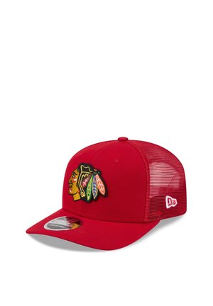 Red mesh baseball cap with multicolored Native American head logo embroidered on front and white brand logo on side.