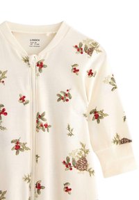 Light cream baby onesie with a front zipper, featuring a botanical print of red berries, green leaves, and pine cones. Cotton fabric, soft texture.
