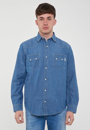 Camicia button-up in denim, blu chiaro, maniche lunghe, due tasche sul petto con alette appuntite, bottoni a pressione, cuciture semplici lungo le cuciture.