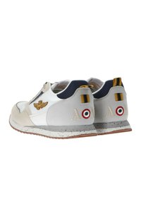Sneakers da uomo con tomaia in mesh bianco, accenti in suede grigio, logo ricamato e suola maculata; presentano i colori della bandiera italiana e una linguetta posteriore a righe.