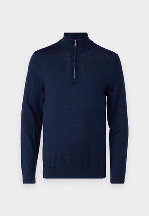 Pull bleu marine à manches longues avec un col à zip quart. Texture lisse, design ajusté, détails de couture minimaux et sans logos visibles.