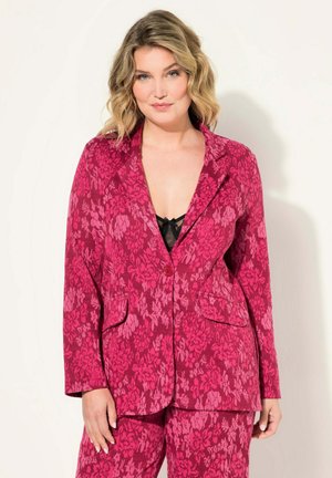 Pink floral-patterned blazer with a single button closure, notched lapels, and front pockets; fabric has a textured finish.