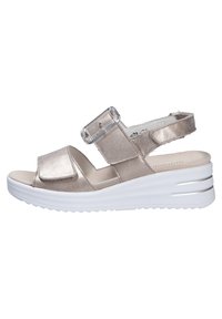 Metallic gold slide sandal with adjustable strap, soft footbed, and a white wedge sole featuring horizontal grooves. Minimalistic design.