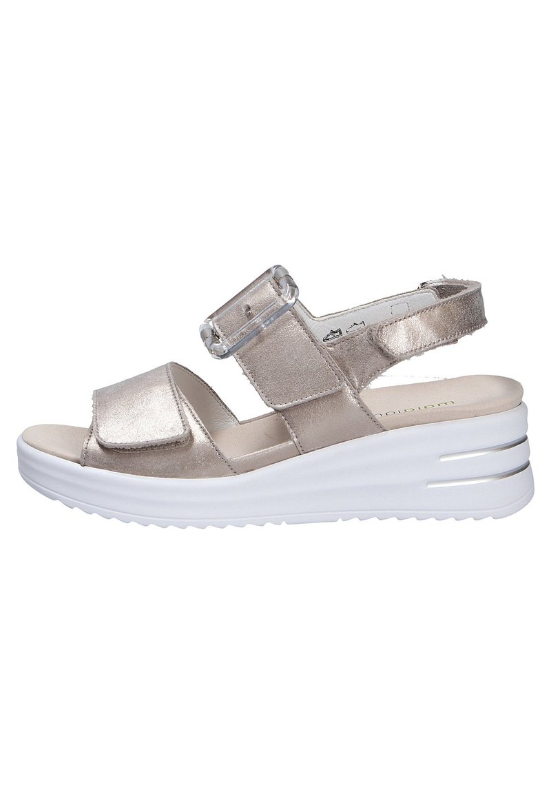 Metallic gold slide sandal with adjustable strap, soft footbed, and a white wedge sole featuring horizontal grooves. Minimalistic design.