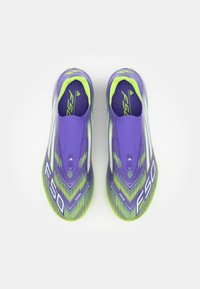 Purple athletic shoes with green accents, sleek, streamlined design, featuring a textured upper and white 'F50' branding on the side.