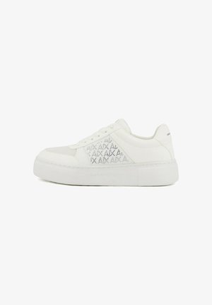 White low-top sneaker with thick sole, laces, and subtle embossed text detailing on the side panel.