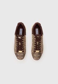 Brown patterned sneakers with a textured fabric upper, gold accents, and brown laces. Features a white rubber sole and logo on the heel.