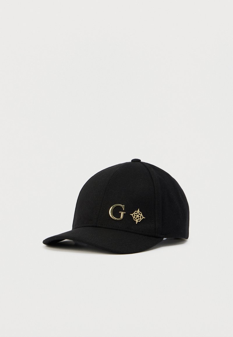 Casquette de baseball noire à visière rigide, ornée d'accents dorés "G" et d'un logo de boussole sur le devant, en tissu texturé.
