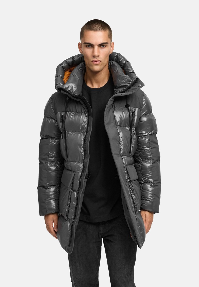 Dark gray puffer jacket with shiny finish, oversized hood, orange inner lining, zippered pockets, and elastic drawstrings at the waist.