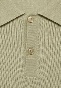 Green short-sleeve polo shirt featuring a textured knit pattern, a fold-down collar, and two light-colored buttons at the placket.