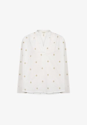 White blouse featuring a V-neck, long sleeves, and subtle gold diamond embroidery evenly distributed across the fabric. Soft texture.