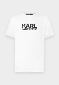 Valge puuvillane T-särk lühikeste varrukatega, millel on must graafiline disain, kus on tekst "KARL LAGERFELD" ja siluettlogo.
