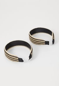 Pair of braided headbands featuring black and beige stripes, with a smooth inner lining and fabric-covered ends for comfort.