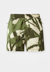 Grønne og beige badetights med kaktusmønster, elastisk talje, snor og sidelommer. Holdbart materiale med tekstureret overflade.