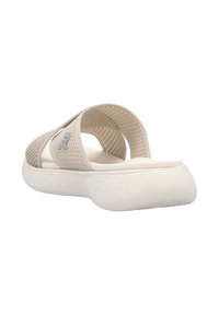 Beige knit sandals with two wide straps, a textured sole, and a cushioned footbed. Features a subtle logo on one strap.