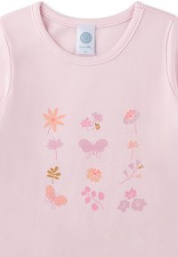 Helles rosa Baumwollhemd mit rundem Ausschnitt, versehen mit einem Blumen- und Schmetterlingsdruck in sanften Rosa-, Orange- und Goldtönen.