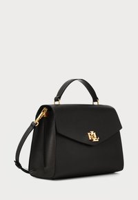 Black leather handbag with a structured shape, smooth texture, gold hardware, and a magnetic flap closure featuring a logo accent.