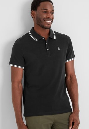 Black polo shirt with white striped accents on the collar and sleeves, featuring a small logo on the chest, made of cotton fabric.
