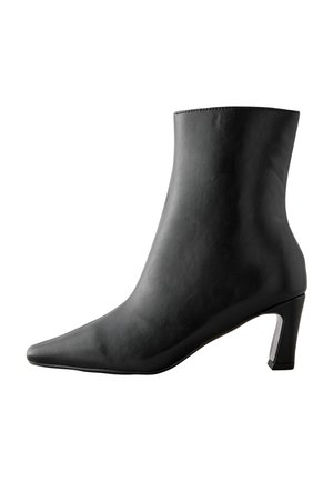 Black leather ankle boot with a pointed toe and a tapered heel. The design features a smooth texture and a sleek silhouette.