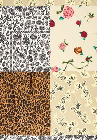 Tela de patchwork con patrones florales, estampado animal y diseños abstractos en negro, beige y varios colores, que exhibe texturas y diseños diversos.