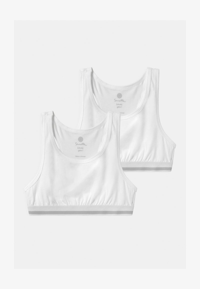 To hvite bomullskorstopper med brede stropper, strikket bunnkant og subtil merkevare på den indre kragen.