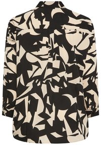 Chemise à manches longues noir et crème avec un motif géométrique abstrait, présentant un poignet à boutons et un détail de empiècement au dos.