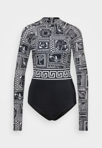 Maillot de bain à manches longues noir avec des motifs graphiques blancs. Il présente un col haut et une silhouette ajustée. Fermeture éclair au dos.