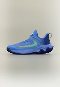 Μπλε αθλητικό παπούτσι με σόλα σε κυματιστό σχέδιο, ανοιχτό μπλε και χρυσό λογότυπο swoosh και θηλιά στο πίσω μέρος.