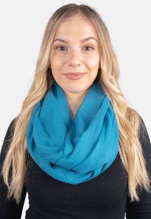 Teal infinity scarf made of a lightweight, soft fabric, featuring a loose drape. Worn around the neck, with a smooth texture.