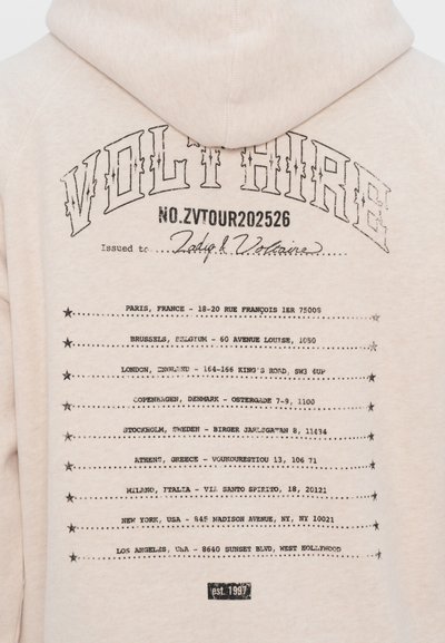 Beige hoodie featuring black printed text. Design includes 'VOLT HIRE' at the top and location details in a list format on the back.