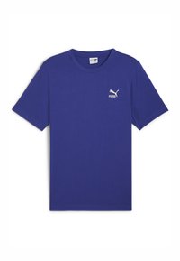 Fialové bavlněné tričko s kulatým výstřihem a krátkými rukávy. Na levém prsu se nachází bílé logo Puma.
