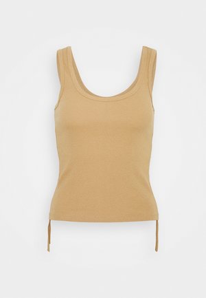 Débardeur côtelé couleur beige avec un col dégagé, des manches courtes, et des accents à cordon de serrage à l'ourlet pour ajuster la longueur.